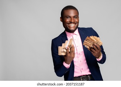 Excited And Happy Young African Man Holding A Lot Of Money That He Has Won