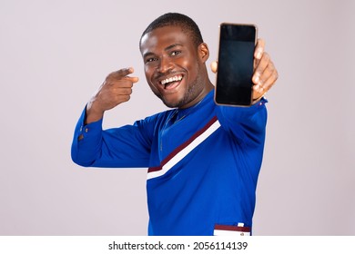 Excited And Happy Young African Man Showing His Phone Screen To The Camera