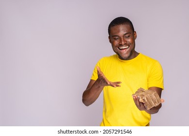 Excited And Happy Young African Man Holding A Lot Of Money