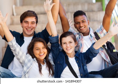 Excited High School Students With Arms Outstretched Outdoors