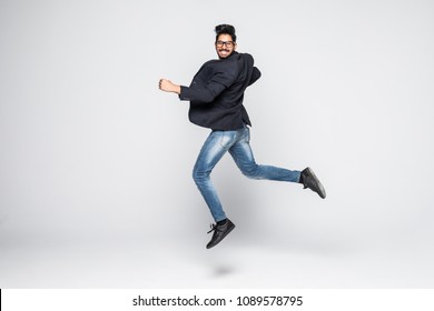 Excited Indian businessman jumping for joy. Isolated on white background. - Shutterstock ID 1089578795