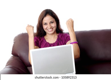 Excited Indian woman working with laptop