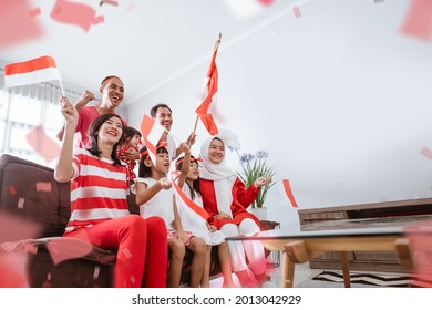 Excited Indonesian Family Supporter While Watching Sport Match At Television At Home Together