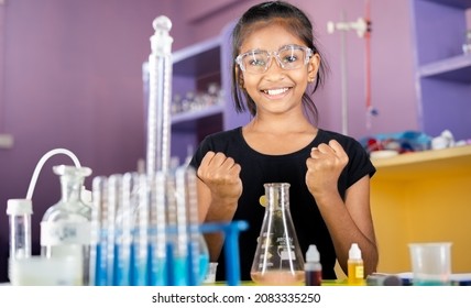 Excited Kid celebrating over successful science experiment result or chemical reaction at chemistry laboratory - concept of child prodigy, intelligent and smart. - Powered by Shutterstock