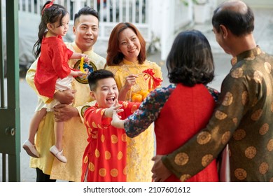 Excited kid happy to visit his grandparents for Chinese New Year family reunion - Shutterstock ID 2107601612