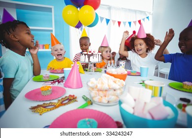 Excited Kids Enjoying A Birthday Party With Lots Of Sweets