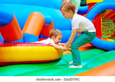 excited kids having fun on inflatable attraction playground - Shutterstock ID 316207592