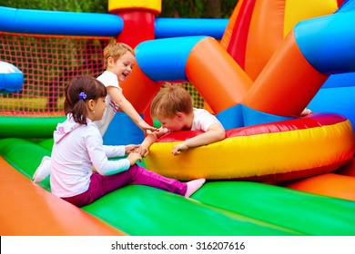 excited kids having fun on inflatable attraction playground - Shutterstock ID 316207616