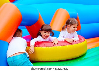 excited kids having fun on inflatable attraction playground - Shutterstock ID 316207622