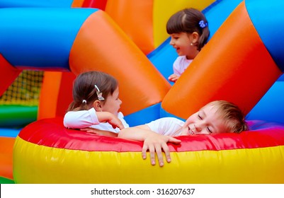 excited kids having fun on inflatable attraction playground - Shutterstock ID 316207637