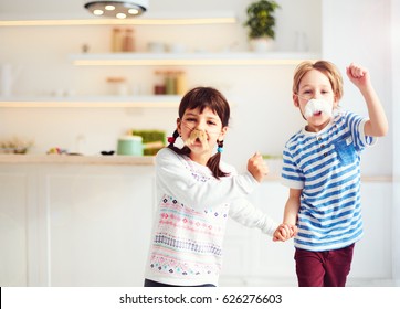 Excited Kids With Mustaches Having Fun On Kitchen At Home