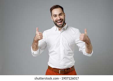 Excited Laughing Confident Young Bearded Business Man Wearing Classic White Shirt Showing Thumbs Up Like Gesture Isolated On Grey Color Background Studio Portrait. Achievement Career Wealth Concept