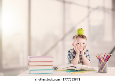 Excited little kid schoolboy with an apple on the head study - Shutterstock ID 1777533971