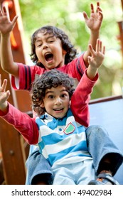 Excited Little Kids Playing At The Park