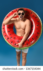 Excited Man With Inflatable Ring On Color Background