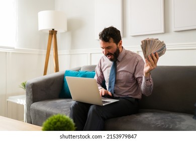 Excited Man With A Lot Of Money Celebrating His High Income And Looking At His Savings On The Online Bank