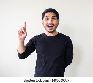 Excited Man Pointing Up With A New Idea, Smiling Young Asian Man Looking And Pointing Up, Smiling Young Asian Man Pointing His Index Finger Up.