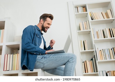 Excited Man Showing Yeah Gesture While Looking At Laptop