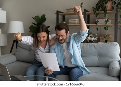 Excited Married Couple Hug On Couch Yell Yes Read Paper Letter About Getting Tax Refund Money Grant For Family Business. Amazed Young Spouses Overjoyed By Perfect Conditions Of Loan Mortgage Agreement