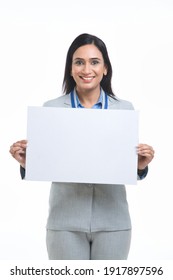 Excited mature woman holding empty white board over white background.
