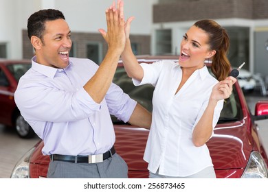 Excited Mid Age Couple Giving High Five After Buying New Car