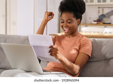 Excited Millennial African American Woman Sitting On Couch At Home, Holding And Reading Paper Document, Feel Euphoric. Black Girl Receiving Job, Enjoy Exam Results Or College Admission Letter.