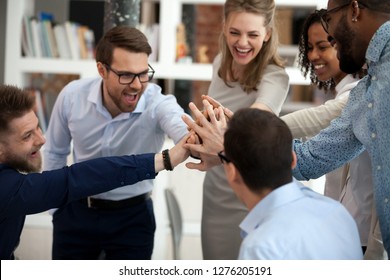 Excited Motivated Multi-ethnic Team People Give High Five, Happy Diverse Office Employees Executive Group Celebrate Corporate Success, Sharing Victory, Engaged In Unity Support Teambuilding Concept