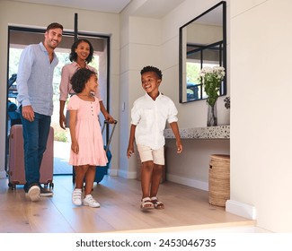 Excited Multi Racial Family With Luggage Arriving In House Or Apartment For Summer Vacation - Powered by Shutterstock