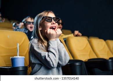 Excited Multicultural Friends In 3d Glasses Watching Movie In Cinema Together