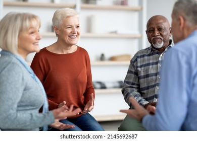 Excited Multiethnic Elderly People Attending Group Therapy Session At Nursing House, Positive Senior Man And Woman Sitting In Circle, Having Conversation With Psychologist And Gesturing, Closeup