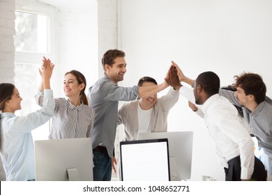Excited Multiracial Colleagues Celebrating Team Victory Giving High Five In Office, Happy Employees Group Join Hands Together Promising Loyalty Engagement, Expressing Trust Unity Support In Teamwork