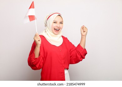 excited muslim woman holding indonesian flag on indonesia independence day on isolated white background