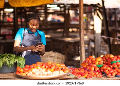 Excited Nigerian Market Woman Feeling Excited While Using Her Phone