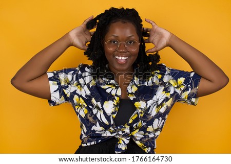 Excited  overjoyed African American woman screams after receiving good news, keeps hands on head, can't believe it.
