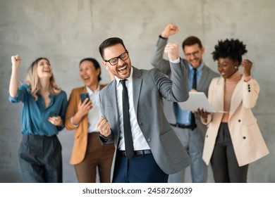 Excited overjoyed diverse business people, team celebrate corporate victory together in office - Powered by Shutterstock