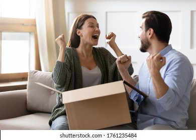 Excited Overjoyed Man And Woman Unpacking Awaited Parcel Together, Happy Young Couple Celebrating Success, Lottery Winner Prize, Satisfied Clients Customers Received Order, Good Delivery Service