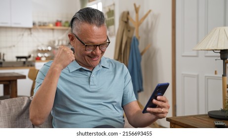 Excited Overjoyed Older Man Winner Holding Smartphone Feeling Euphoric With Mobile Online Bet Bid Game Win, Happy Senior Chinese Guy Looking At Cell Phone Celebrate Receiving Reading Good News