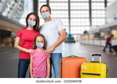 Excited Parents And Little Child In Medical Face Masks Waiting For Flight At Airport Terminal - Shutterstock ID 2105040938