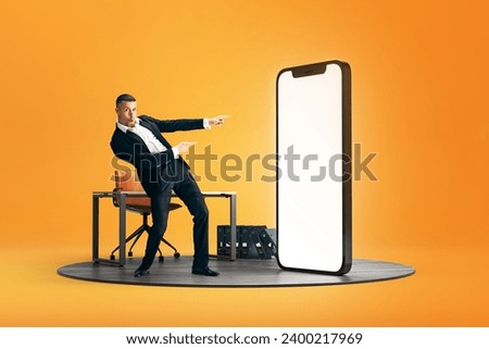 Excited proposal. Businessman pointing at giant 3D model phone with empty screen over yellow background. Promotion. Mockup for text, ad, design, logo. Concept of business, online service, e-commerce