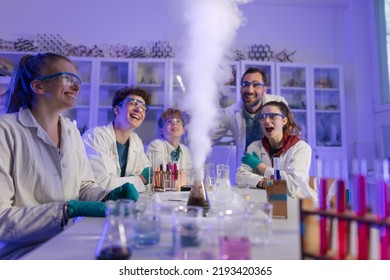 Excited science students with teacher doing chemical experiment in the laboratory at university. - Powered by Shutterstock