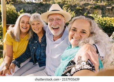 Excited senior friends taking a selfie together during vacation. Cheerful elderly people enjoying a weekend getaway at a spa resort. Group of happy senior citizens having fun after retirement. - Powered by Shutterstock