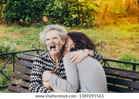 Similar – Woman taking selfie with older mother in wheelchair