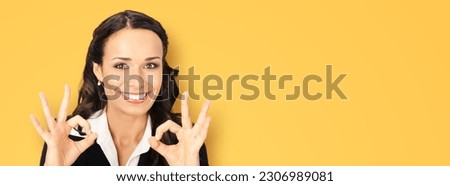 Excited smile positive businesswoman wear black confident suit show make ok okay hand sign, isolated orange yellow background. Happy gesturing woman. Business success ad concept. Wide banner image.