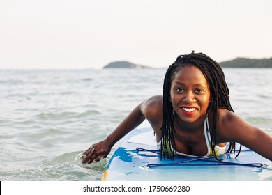 Excited Smiling Pretty Young Black Woman Swimming On Sup Board In Sea