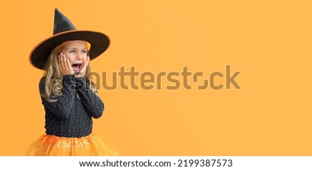 Excited suprise wow open mouth kid girl wearing witch hat costume Halloween isolated yellow studio background. Seasonal sale and discount. Shopping attentive. Banner, copy space for text, mock up