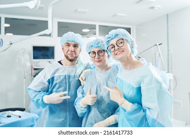 Excited Surgical Team Posing For Photo In Operation Room