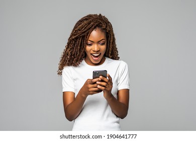 Excited Woman Texting On Her Phone Isolated Over White Background