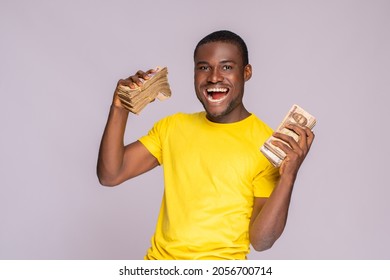 Excited Young African Man Holding A Lot Of Money