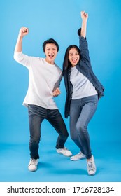 Excited Young Asian Couple Man And Woman Happy Celebrate Success Over Blue Background, Winner Concept