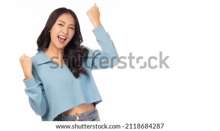 Excited young asian female with raised hands celebrating success Portrait cheerful positive asian woman with raised hands and fists open mouth Girl get happy, enjoy life isolated on white copy space